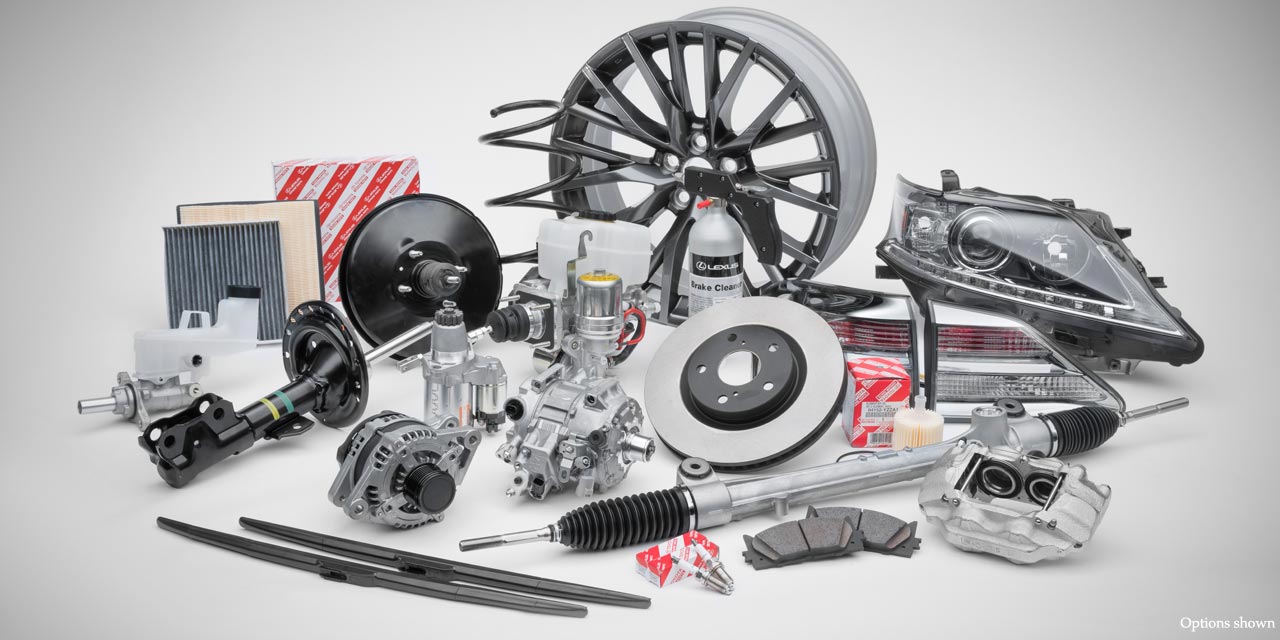Genuine Lexus replacement parts laid out together: wheel, brake rotor, calipers, filters, alternator and headlamp